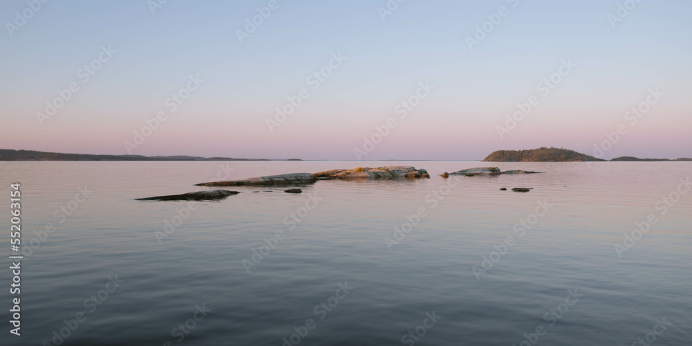 Rocks inhabited with birds on a lake in norther Europe Rocks inhabited with birds on a lake in norther Europe