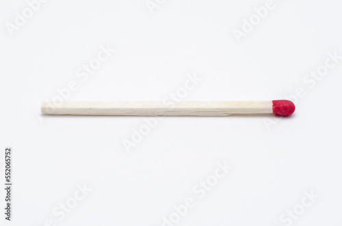 One single new unlit matchstick on white background