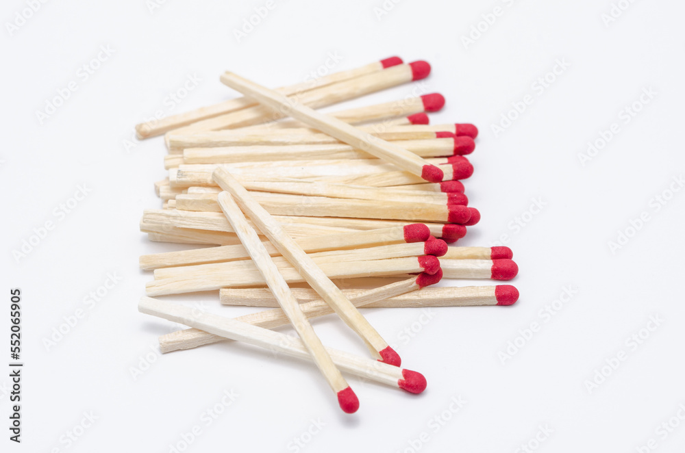 Pile of new unlit wooden matchsticks on white background