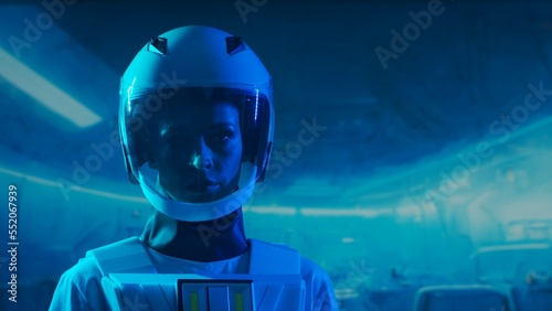 A woman astronaut in a space suit aboard the orbital station. A young female cosmonaut pilots a spaceship. Galactic travel and science concept.