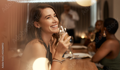Happy, dinner party and woman with glass of champagne for special celebration event, friendship reunion or New Year. Fine dining restaurant, friends and elegant girl with alcohol drink to celebrate photo