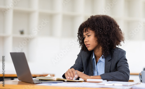 Feeling tired and stressed, workload, burnout and fatigue. Frustrated young african american woman keeping eyes closed and massaging nose after work at laptop for long time in office