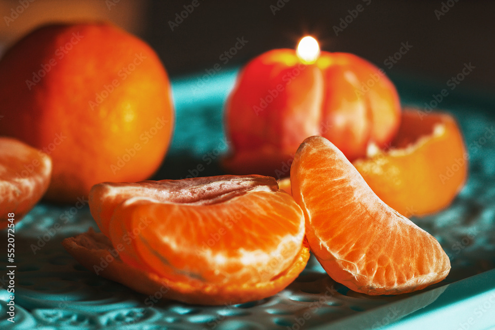 A burning candle in the shape of a tangerine. Holiday advent. Beautiful handmade candles. A burning candle in the shape of a tangerine. Holiday advent. Beautiful handmade candles.
