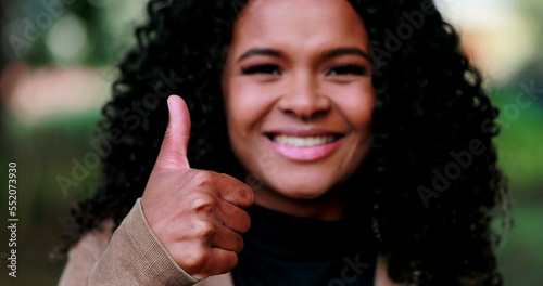 Positive Black woman giving approval with thumb up