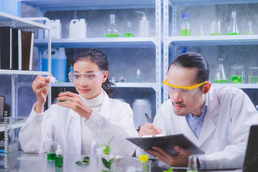 A Female Scientist is dropping the test liquid of the result of laboratory eco or natural cosmetic, medicine, organic skin care. Concept of Eco experiment, botany and studying. focus on hand. A Female Scientist is dropping the test liquid of the result of laboratory eco or natural cosmetic, medicine, organic skin care. Concept of Eco experiment, botany and studying. focus on hand.