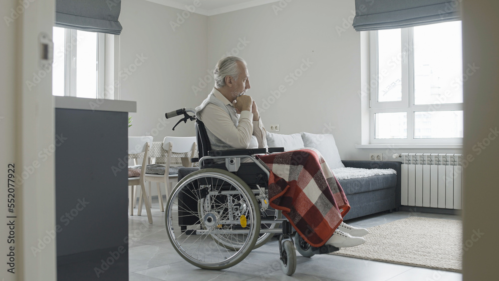 Unhappy senior man in wheelchair feeling sad, life with disability, nursing home Unhappy senior man in wheelchair feeling sad, life with disability, nursing home