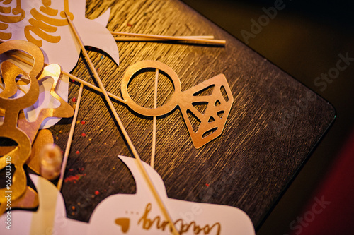 An engagement ring in the form of cardboard on a stick lies on the table. Holiday boards.