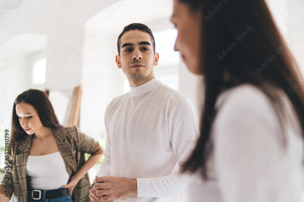Friendly coworkers talking to each other during break at work Friendly coworkers talking to each other during break at work