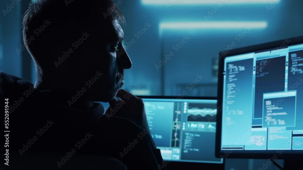 Computer Hacker in Hoodie. Obscured Dark Face. Hacker Attack, Virus Infected Software, Dark Web and Cyber Security concept Computer Hacker in Hoodie. Obscured Dark Face. Hacker Attack, Virus Infected Software, Dark Web and Cyber Security concept