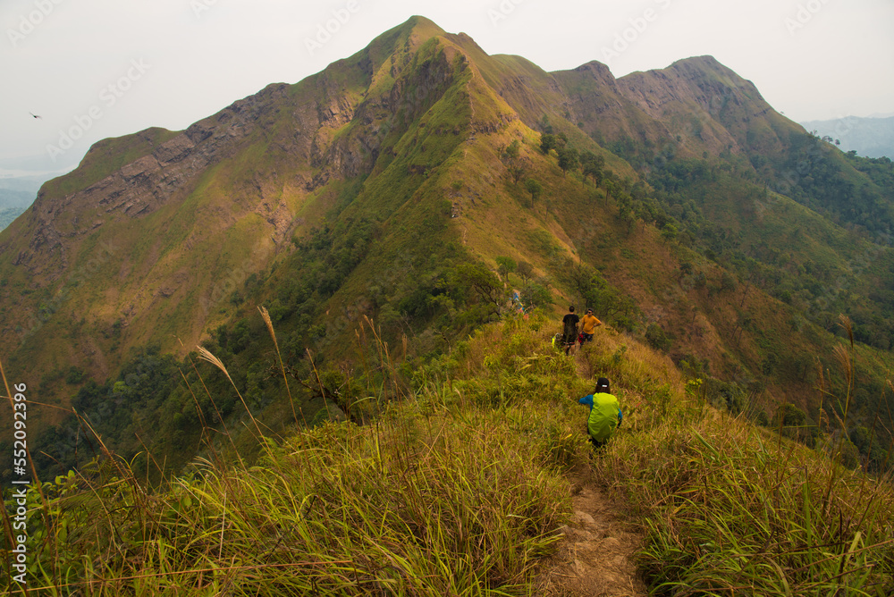 Hikers on top of a mountain at Khao Chang Phueak, Kanchanaburi, Thailand Hikers on top of a mountain at Khao Chang Phueak, Kanchanaburi, Thailand