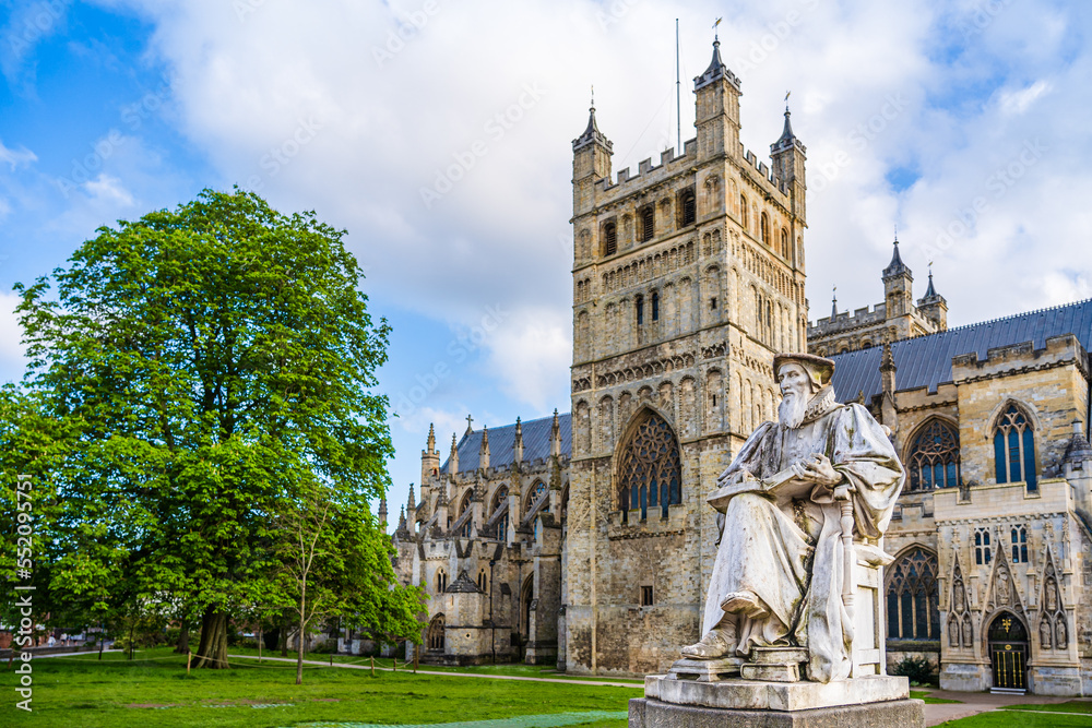 Exeter, Devon, England, UK: Statue of Richard Hooker (1553 - 1600) in front of Exeter Cathedral, the Cathedral Church of Saint Peter in Exeter