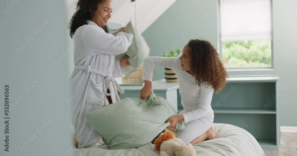 Mother, child and smile for pillow fight on bed for morning happiness, playful fun and quality time together. Happy parent, child laughing and crazy, funny and comic bonding with pillows in bedroom Mother, child and smile for pillow fight on bed for morning happiness, playful fun and quality time together. Happy parent, child laughing and crazy, funny and comic bonding with pillows in bedroom