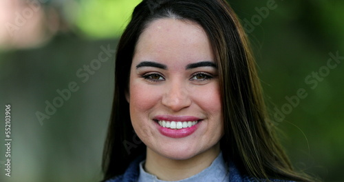 Young woman portrait smiling at camera outside