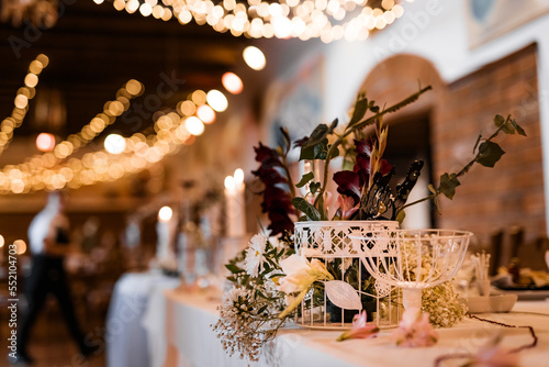 Table setting for wedding party decor flowers lights blurred background