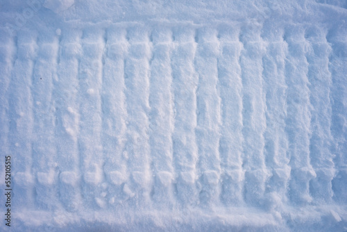 snowmobile trail on melted snow. Winter time
