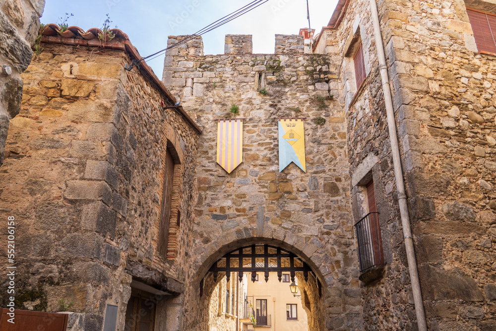 Fortress door with two shields at Sant Llorenç de la Muga, a medieval town in Girona, Spain.