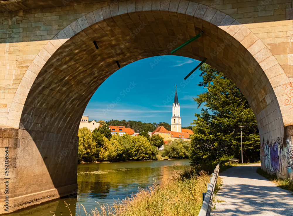 Beautiful summer view with reflections, an ancient bridge and a church at Vilshofen, Danube, Bavaria, Germany