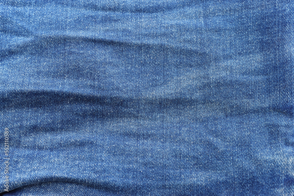 close up of worn blue jeans cloth fabric close up of worn blue jeans cloth fabric