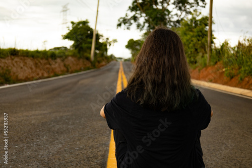 woman siting on the road