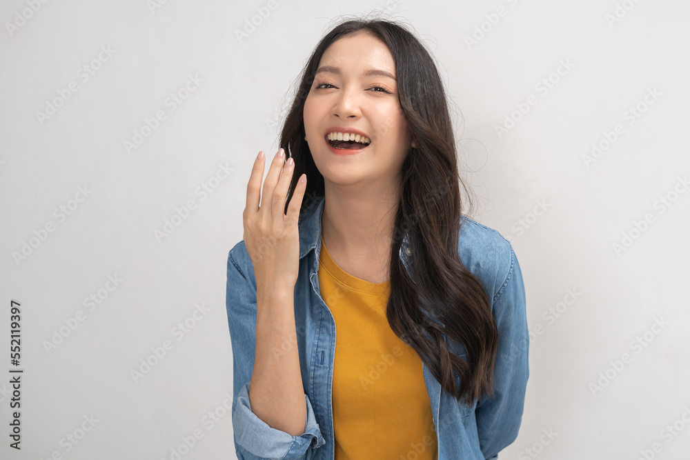 Smiling positive, attractive asian young woman wearing casual dress, portrait of beautiful brunette her with long black hair, feeling happy looking at camera standing isolated on white background. Smiling positive, attractive asian young woman wearing casual dress, portrait of beautiful brunette her with long black hair, feeling happy looking at camera standing isolated on white background.