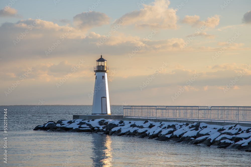 Sandspit Lighthouse and fishing pier in snow during winter, Patchogue Long Island New York
