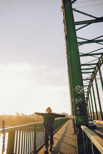 Фотография person walking on the bridge