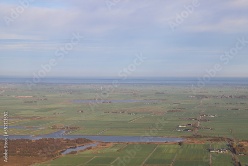 Beautiful Aerial view from a hot air balloon over Frisian countryside, the Netherlands with the Wadden Sea in the distance.