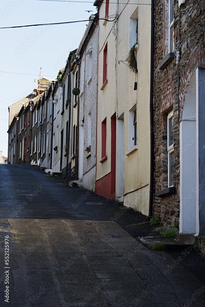 Old narrow street in County Wexford, Ireland with traditional small houses.