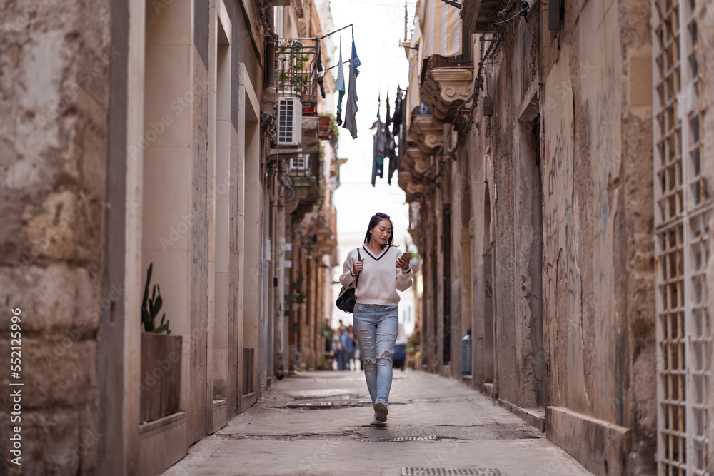 Female tourist walking on street in old town Female tourist walking on street in old town