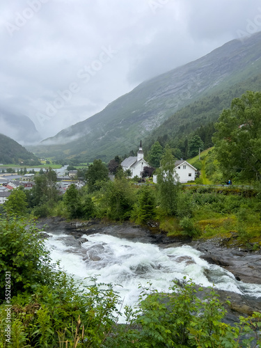 landscape with river,  mountains and an old white church in Norway