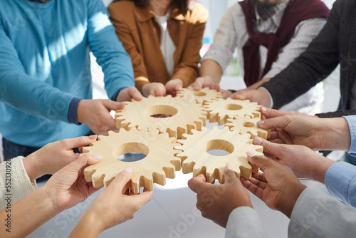 Team of people connecting gear wheels. Group of men and women joining cog wheels. Business, teamwork, effective work, project management, innovation, integration concepts