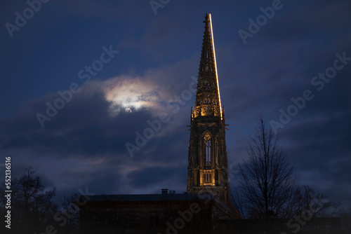 St Lamberti Church, one of the symbols of Munster, and the full moon.  Christmas lighting in St Lamberti Church: Himmelleiter. Church and full moon. gothic  Wallpaper. 06.12.2022 Munster in Germany. © M.Nergiz