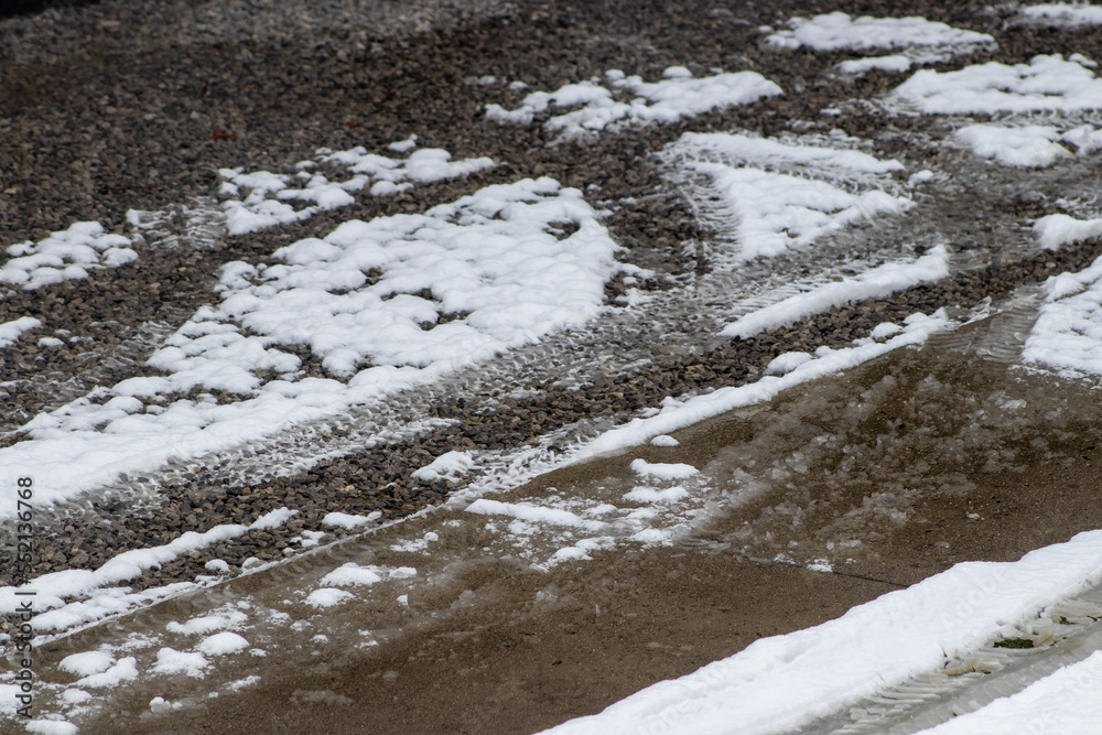 Obraz premium Snowy brick footpath, close up. Winter snow ground outdoor