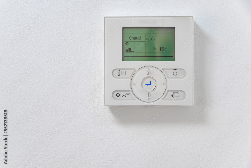 Close-up electronic thermostat on a white wall Close-up electronic thermostat on a white wall