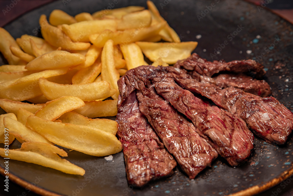 Beef picanha with fried potato on a plate Beef picanha with fried potato on a plate