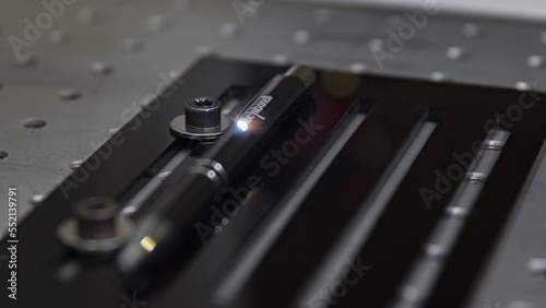 Close-up laser engraving action on a black pen