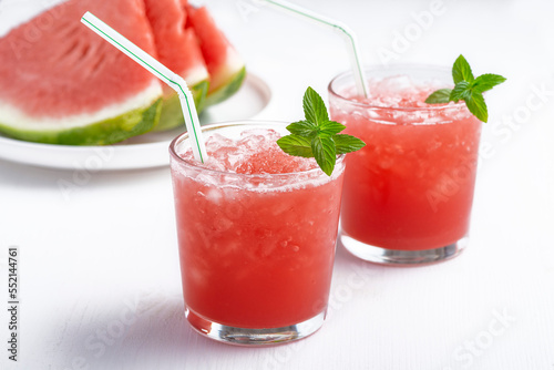 Summer cold drink with watermelon and mint on a wooden background. Copy space