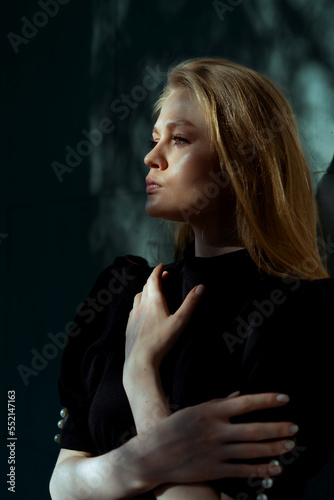 Dramatic Portrait Of Beautiful Elegant Lady With Trees Shadows At Her Face And Background. Actress Showing Mourning Widow Or Sadness