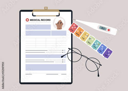 A set of senior patient's medical chart clipped to a clipboard, pill box, glass frames, and plastic thermometer
