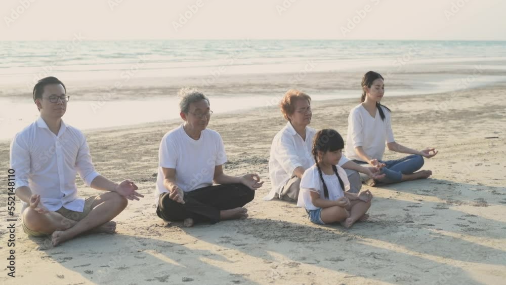 Holiday concept of 4k Resolution. Everyone in the family is doing yoga by the beach. summer vacation travel. Holiday concept of 4k Resolution. Everyone in the family is doing yoga by the beach. summer vacation travel.