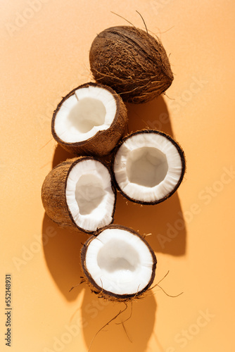 Summer mood with coconuts on yellow background. Top view. Vertical photography.