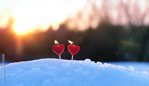 red candles heart on snow, abstract blurred natural background. beautiful winter landscape with burning romantic candles. symbol of love, romance, happiness, Valentine's day. witch ritual for lovers.