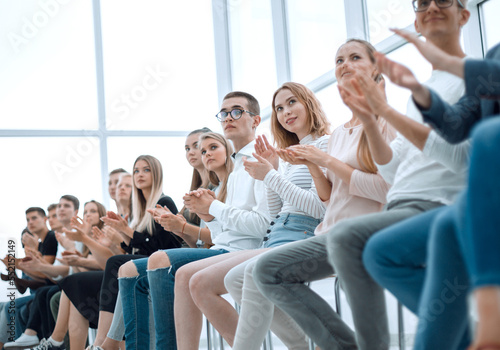 group of diverse young people sitting in a row