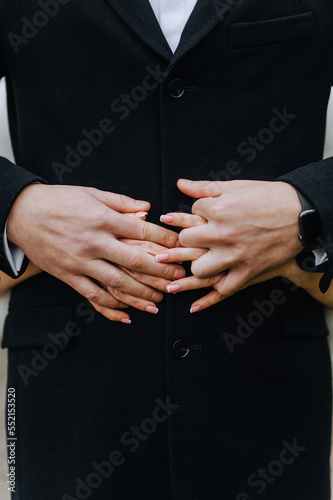 Hands  fingers of the bride and groom  man and woman together. Wedding photography  portrait.