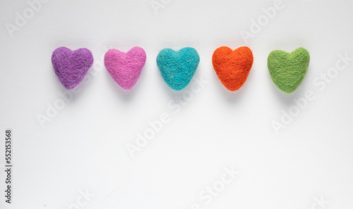 Colourful felt hearts on a white background