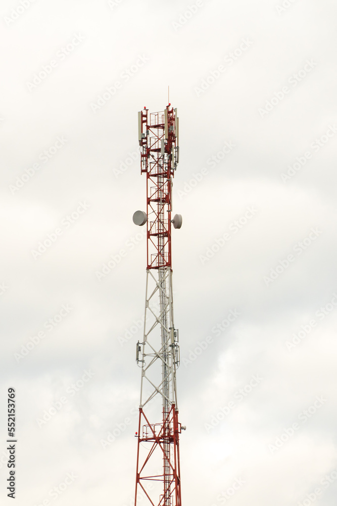 New GSM antennas on a high tower against a blue sky for transmitting a 5g signal are dangerous to health. Radiation pollution of the environment through cell towers. The threat of extinction New GSM antennas on a high tower against a blue sky for transmitting a 5g signal are dangerous to health. Radiation pollution of the environment through cell towers. The threat of extinction