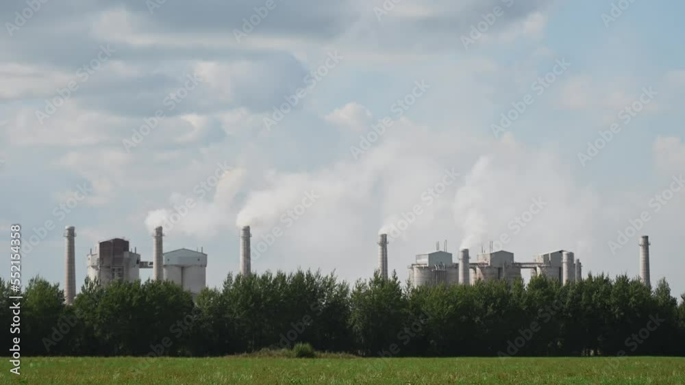 Tall chimneys of a factory with smoke rising up, polluting the atmosphere. Air pollution concept,ecological environment. High quality 4k footage Tall chimneys of a factory with smoke rising up, polluting the atmosphere. Air pollution concept,ecological environment. High quality 4k footage