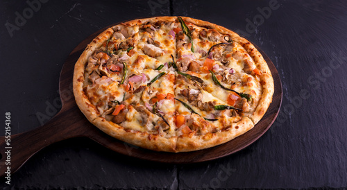 Tropical Chicken cheese pizza isolated on cutting board top view on dark background italian fast food