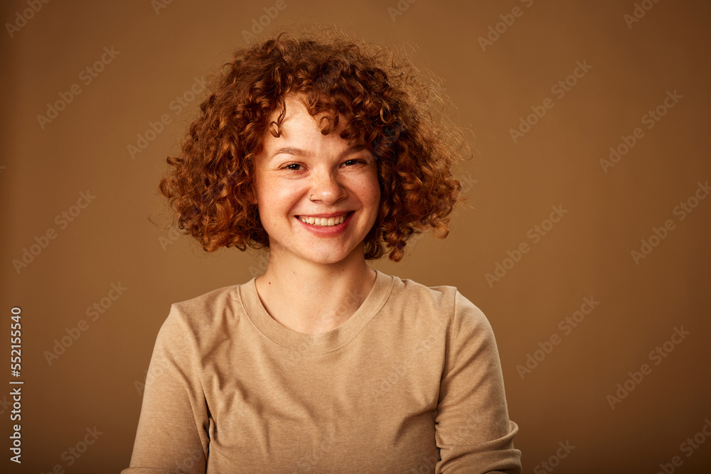 Portrait of a cute ginger girl with curly hair. Portrait of a cute ginger girl with curly hair.