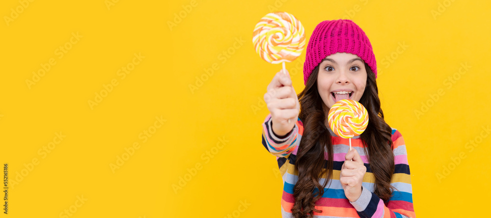 yummy. selective focus. happy teen girl licking lollipop. lollipop lady. kid with colorful lollypop. Teenager child with sweets, poster banner header, copy space.